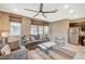 Comfortable living room featuring modern furnishings, a ceiling fan, and natural light through multiple windows at 1541 Unison Way # 102, Las Vegas, NV 89135