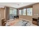 Bright living room featuring a slider to a patio, three large windows and a decorative area rug at 1541 Unison Way # 102, Las Vegas, NV 89135