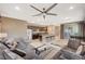 Open-concept living space with a modern kitchen, island seating, and comfortable furnishings at 1541 Unison Way # 102, Las Vegas, NV 89135