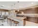 Open concept living area with an island featuring bar stool seating and stainless steel appliances at 1541 Unison Way # 102, Las Vegas, NV 89135