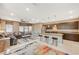 Open-concept living space with kitchen island, seating area, and natural light from large windows at 1541 Unison Way # 102, Las Vegas, NV 89135