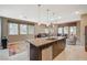 Open-concept space with a large kitchen island, seating, and natural light from many windows at 1541 Unison Way # 102, Las Vegas, NV 89135