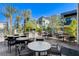 Community outdoor grilling area with multiple grills, seating, and lush landscaping for social gatherings at 1541 Unison Way # 102, Las Vegas, NV 89135