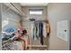 Walk-in closet with custom shelving, hanging rods, and a small window at 1541 Unison Way # 102, Las Vegas, NV 89135