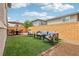 Spacious backyard with seating and dining areas for outdoor relaxation and entertainment on artificial turf at 160 Lilt Ave, Henderson, NV 89011