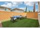 Lush backyard with artificial turf, a comfortable seating area, and privacy fencing for relaxing outdoors at 160 Lilt Ave, Henderson, NV 89011