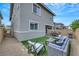 Relaxing backyard featuring patio furniture, artificial grass, and an attractive outdoor space at 160 Lilt Ave, Henderson, NV 89011