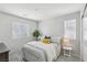 Bright bedroom featuring striped bedding, decorative pillows, and plant accent at 160 Lilt Ave, Henderson, NV 89011