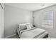 Neutral bedroom with gray and white striped bedding, soft pillows, and a minimalist, clean aesthetic at 160 Lilt Ave, Henderson, NV 89011