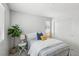 Bright bedroom featuring striped bedding, neutral walls, and a green houseplant accenting the cozy space at 160 Lilt Ave, Henderson, NV 89011