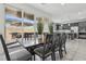 Open dining area features a modern table, seating for six, and sliding glass doors to the patio at 160 Lilt Ave, Henderson, NV 89011