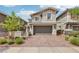 Charming two-story home features a paved brick driveway, two-car garage, and manicured front yard at 160 Lilt Ave, Henderson, NV 89011