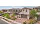Beautiful two-story home with a well-maintained lawn, brick driveway, and attached garage at 160 Lilt Ave, Henderson, NV 89011