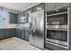 Modern kitchen showcasing stainless steel appliances, grey cabinets and white countertops at 160 Lilt Ave, Henderson, NV 89011
