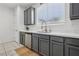 Modern kitchen showcasing white countertops, stainless dishwasher and sink beneath large window at 160 Lilt Ave, Henderson, NV 89011