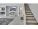 Open-concept living area with staircase, tv and view of the kitchen at 160 Lilt Ave, Henderson, NV 89011