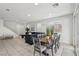 Open-concept living area with staircase, dining table, and cozy sectional sofa at 160 Lilt Ave, Henderson, NV 89011