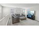 Cozy loft featuring an L-shaped sofa, ottoman, and a modern TV at 160 Lilt Ave, Henderson, NV 89011