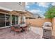Cozy patio with outdoor dining set, grill, and a neatly paved area perfect for summer gatherings at 160 Lilt Ave, Henderson, NV 89011