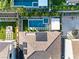 Aerial view of a backyard featuring a pool, patio, solar panels, and lush landscaping at 177 Cactus Sunrise St, Las Vegas, NV 89138