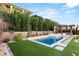 Beautiful backyard with a pristine pool area, manicured lawn, and privacy landscaping at 177 Cactus Sunrise St, Las Vegas, NV 89138