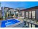 Inviting backyard featuring a modern pool, spa, and covered patio with a stylish seating area and fire feature at 177 Cactus Sunrise St, Las Vegas, NV 89138