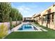 Gorgeous backyard featuring a sparkling pool, lush landscaping, and convenient access to the home's interior at 177 Cactus Sunrise St, Las Vegas, NV 89138