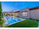 Expansive backyard with a contemporary pool, neat lawn, and seamless transition to indoor-outdoor living at 177 Cactus Sunrise St, Las Vegas, NV 89138