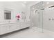 Spacious bathroom with dual vanities, modern mirrors, and a glass shower with dual showerheads at 177 Cactus Sunrise St, Las Vegas, NV 89138