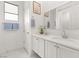 Clean, bright bathroom with double vanity and modern fixtures and decor at 177 Cactus Sunrise St, Las Vegas, NV 89138