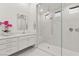 Modern bathroom with a seamless glass shower, marble walls, dual showerheads, and a built-in bench at 177 Cactus Sunrise St, Las Vegas, NV 89138