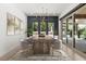 Elegant dining room with modern chandelier and views of the outdoor space, virtually staged for inspiration at 177 Cactus Sunrise St, Las Vegas, NV 89138