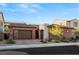 Charming single-story home featuring a brick-accented facade, tile roof, and a spacious driveway, complete with a two-car garage at 177 Cactus Sunrise St, Las Vegas, NV 89138