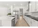 Modern kitchen with stainless steel appliances, an island with sink, and a subway tile backsplash at 177 Cactus Sunrise St, Las Vegas, NV 89138
