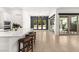 Bright, open kitchen boasts a large island with seating, tile floors, and backyard access at 177 Cactus Sunrise St, Las Vegas, NV 89138