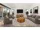 Bright living room with neutral tones, stylish furnishings, and sliding glass doors to the patio at 177 Cactus Sunrise St, Las Vegas, NV 89138
