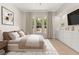 Serene primary bedroom featuring large windows and a minimalist design, virtually staged with modern furniture at 177 Cactus Sunrise St, Las Vegas, NV 89138