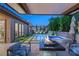 Stunning outdoor living space with pool, spa, fire feature, and covered patio area for relaxing and entertaining at 177 Cactus Sunrise St, Las Vegas, NV 89138