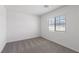 Bright bedroom features a large window and neutral carpet, creating a serene and inviting space at 2606 Lily Point St, Las Vegas, NV 89156