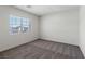 Bright bedroom features a large window and neutral carpet, creating a serene and inviting space at 2606 Lily Point St, Las Vegas, NV 89156