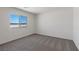 Bright bedroom features a large window and neutral carpet, creating a serene and inviting space at 2606 Lily Point St, Las Vegas, NV 89156