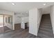 Bright living room with an open concept, featuring stairs and a sliding glass door to the backyard patio at 2606 Lily Point St, Las Vegas, NV 89156