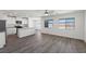 Bright living room featuring an open concept and vinyl floors, complemented by natural light from large windows at 2606 Lily Point St, Las Vegas, NV 89156