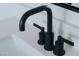 Close up on modern bathroom sink with matte black faucet and quartz countertop at 2616 Tolmezzo St, Henderson, NV 89044
