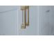Detailed view of sleek, gold cabinet pulls on white cabinetry, showcasing the modern design at 2616 Tolmezzo St, Henderson, NV 89044