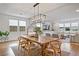 Stylish dining room with a large wooden table, ample seating, and open living space at 2616 Tolmezzo St, Henderson, NV 89044
