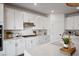 Well-lit kitchen with white cabinetry, quartz countertops, stainless steel appliances, and a subway tile backsplash at 2616 Tolmezzo St, Henderson, NV 89044
