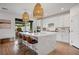 Bright kitchen featuring a large island with a waterfall countertop, pendant lighting and stainless steel appliances at 2616 Tolmezzo St, Henderson, NV 89044