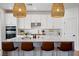Bright, modern kitchen with white cabinets, stainless steel appliances, and stylish pendant lighting at 2616 Tolmezzo St, Henderson, NV 89044