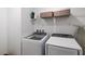 Functional laundry room with modern washer and dryer units and storage shelves at 2616 Tolmezzo St, Henderson, NV 89044